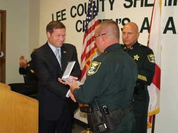 An officer being presented with a Badge of Bravery award