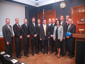 A group of people standing together in a row at the Badge of Bravery awards ceremony