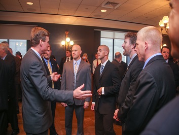 People conversing together in a group at the Badge of Bravery award ceremony