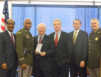 A group of people standing together in a row at the Badge of Bravery awards ceremony