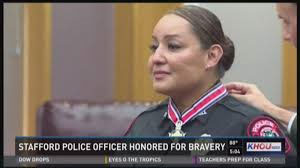An officer being presented with a Badge of Bravery award