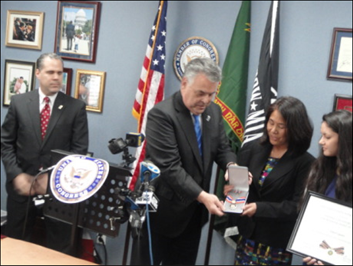 A person being presented with a Badge of Bravery award