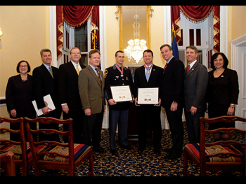 A group of people standing together in a row at the Badge of Bravery awards ceremony