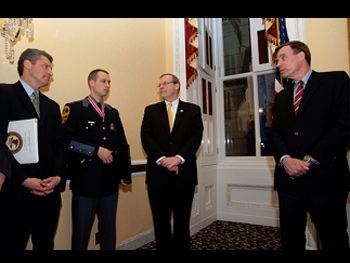 People conversing together in a group at the Badge of Bravery award ceremony