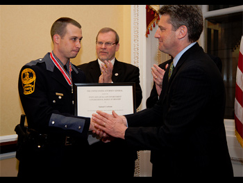 An officer being presented with a Badge of Bravery award