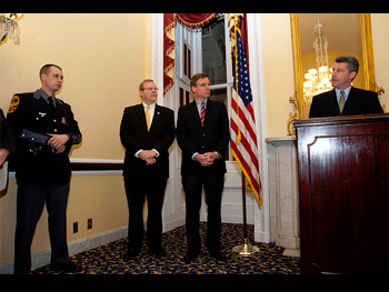 A man giving a speech at the Badge of Bravery awards ceremony