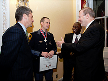 An officer being presented with a Badge of Bravery award