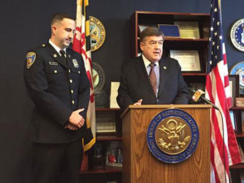 A man giving a speech at the Badge of Bravery awards ceremony