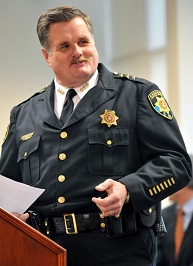 A man giving a speech at the Badge of Bravery awards ceremony