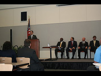A man giving a speech at the Badge of Bravery awards ceremony