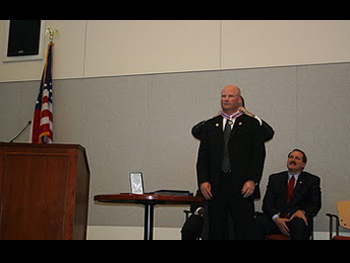 An officer being presented with a Badge of Bravery award