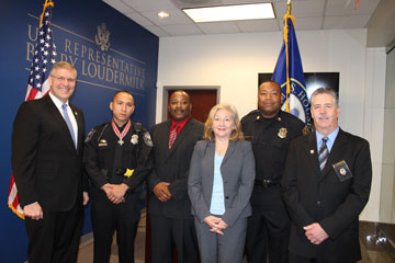 A group of people standing together in a row at the Badge of Bravery awards ceremony