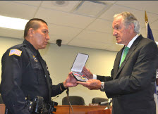 An officer being presented with a Badge of Bravery award