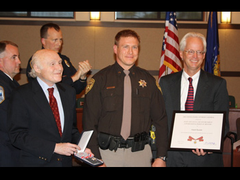 An officer being presented with a Badge of Bravery award