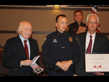 An officer being presented with a Badge of Bravery award