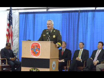 A man giving a speech at the Badge of Bravery awards ceremony