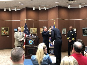 An officer being presented with a Badge of Bravery award