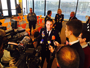 A man being interviewed by the press at the Badge of Bravery award ceremony