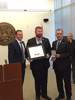An officer being presented with a Badge of Bravery award