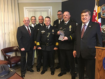 A group of people standing together in a row at the Badge of Bravery awards ceremony