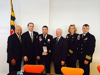 A group of people standing together in a row at the Badge of Bravery awards ceremony