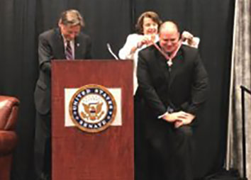 An officer being presented with a Badge of Bravery award