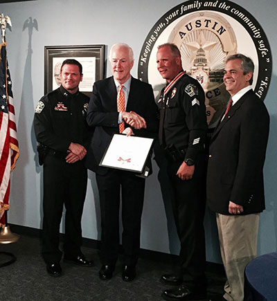 An officer being presented with a Badge of Bravery award