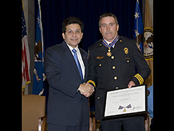 AG Alberto Gonzales and Battalion Chief Gene F. Large, Jr.