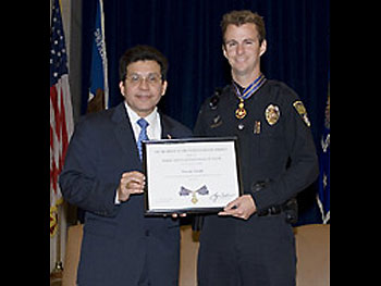 AG Alberto Gonzales and Officer Timothy Greene.