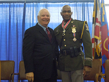 Two people standing together at the Badge of Bravery awards ceremony and smiling at the camera