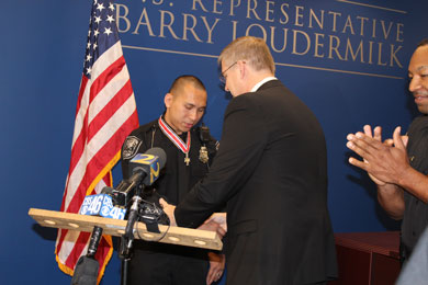 An officer being presented with a Badge of Bravery award