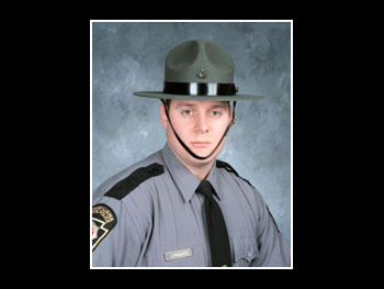 a head and shoulders view of a man in a state trooper uniform facing the camera