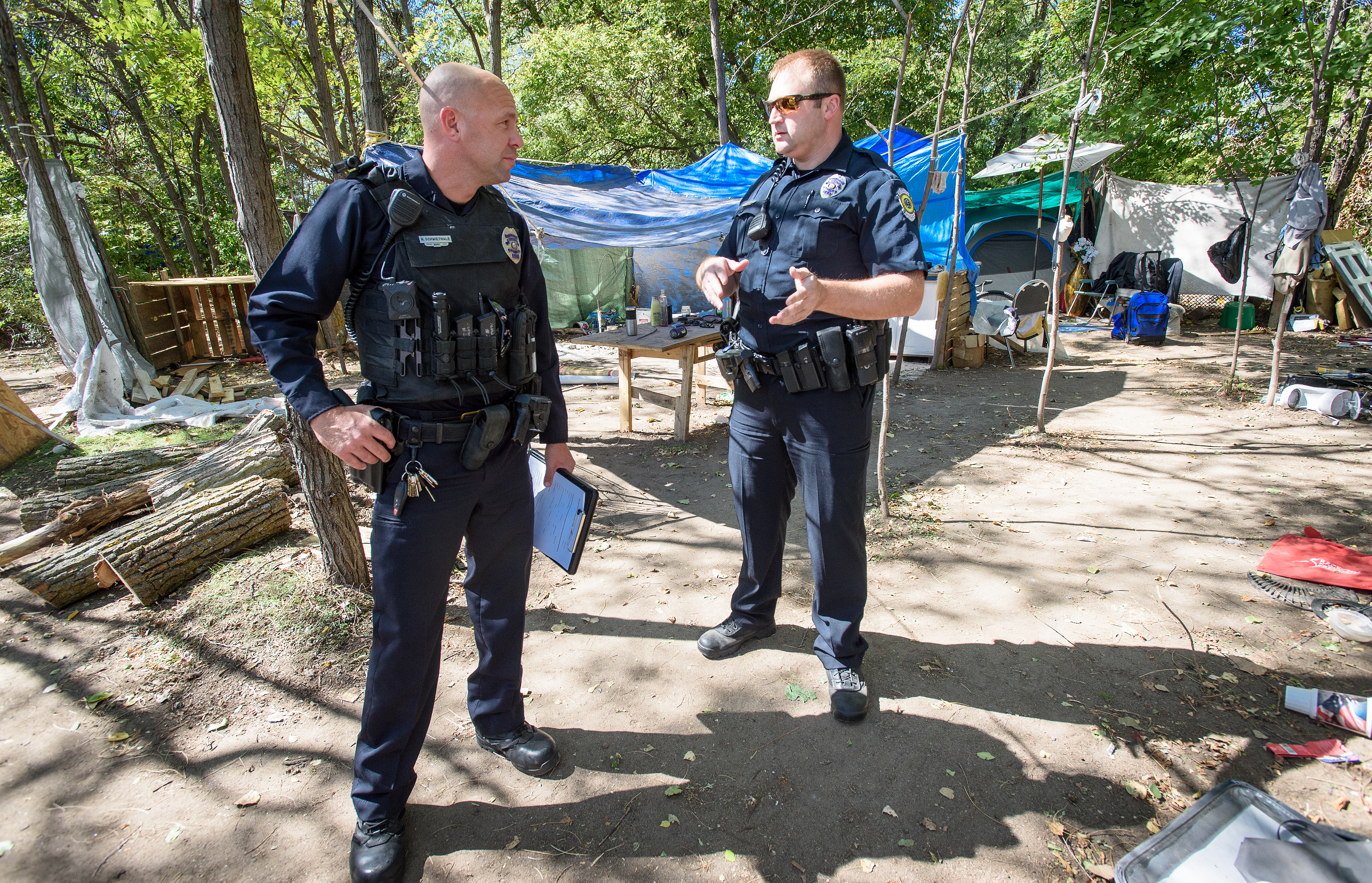 Officers Nate Schweithale and Matthew Lowe of the Wichita, Kansas Police Department Homeless Outreach Team prepare to conduct outreach at an encampment along the Arkansas River