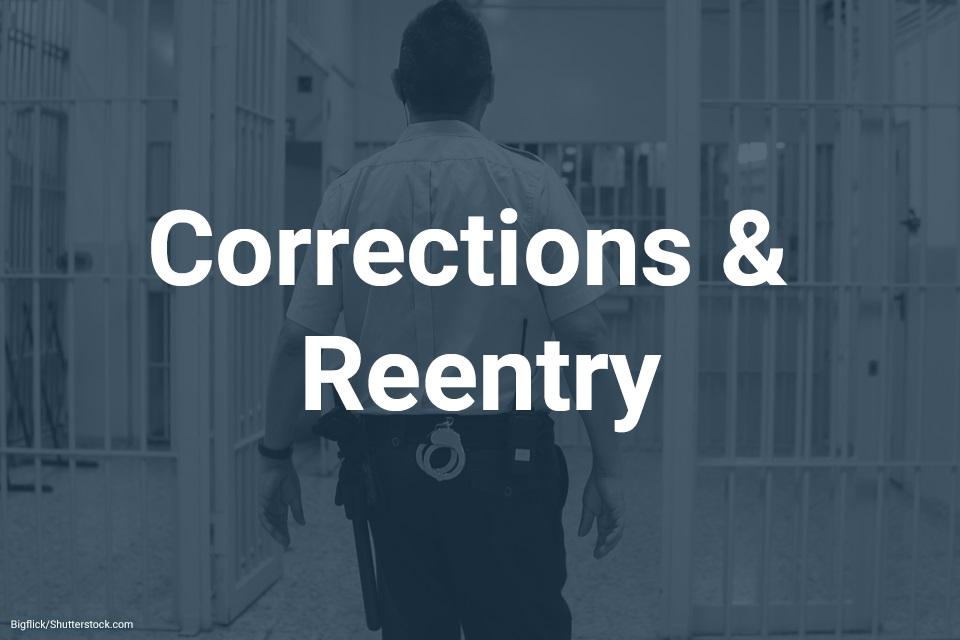 Corrections & Reentry on background of officer walking through facility