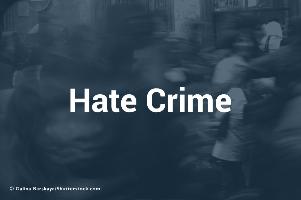 Hate Crime text over blurred street scene