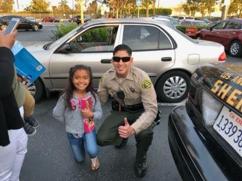 Little girl posing with officer