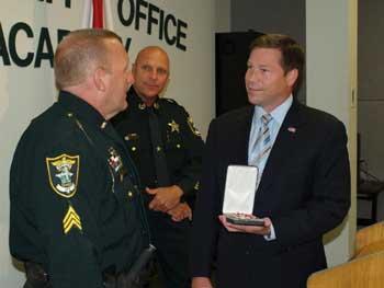 An officer being presented with a Badge of Bravery award