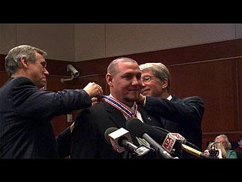 a man receiving the Congressional Badge of Bravery award