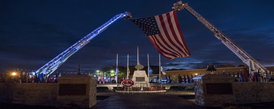 Image of American flag over memorial