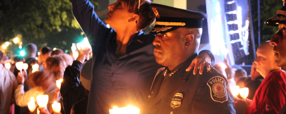 Image of police officer holding candle