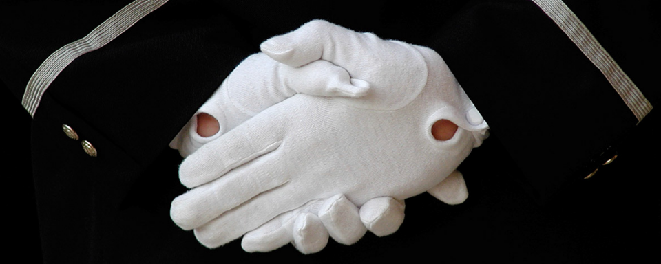 Image of hands in white gloves